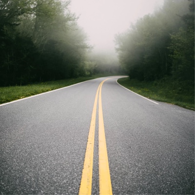 An empty road with looming fog